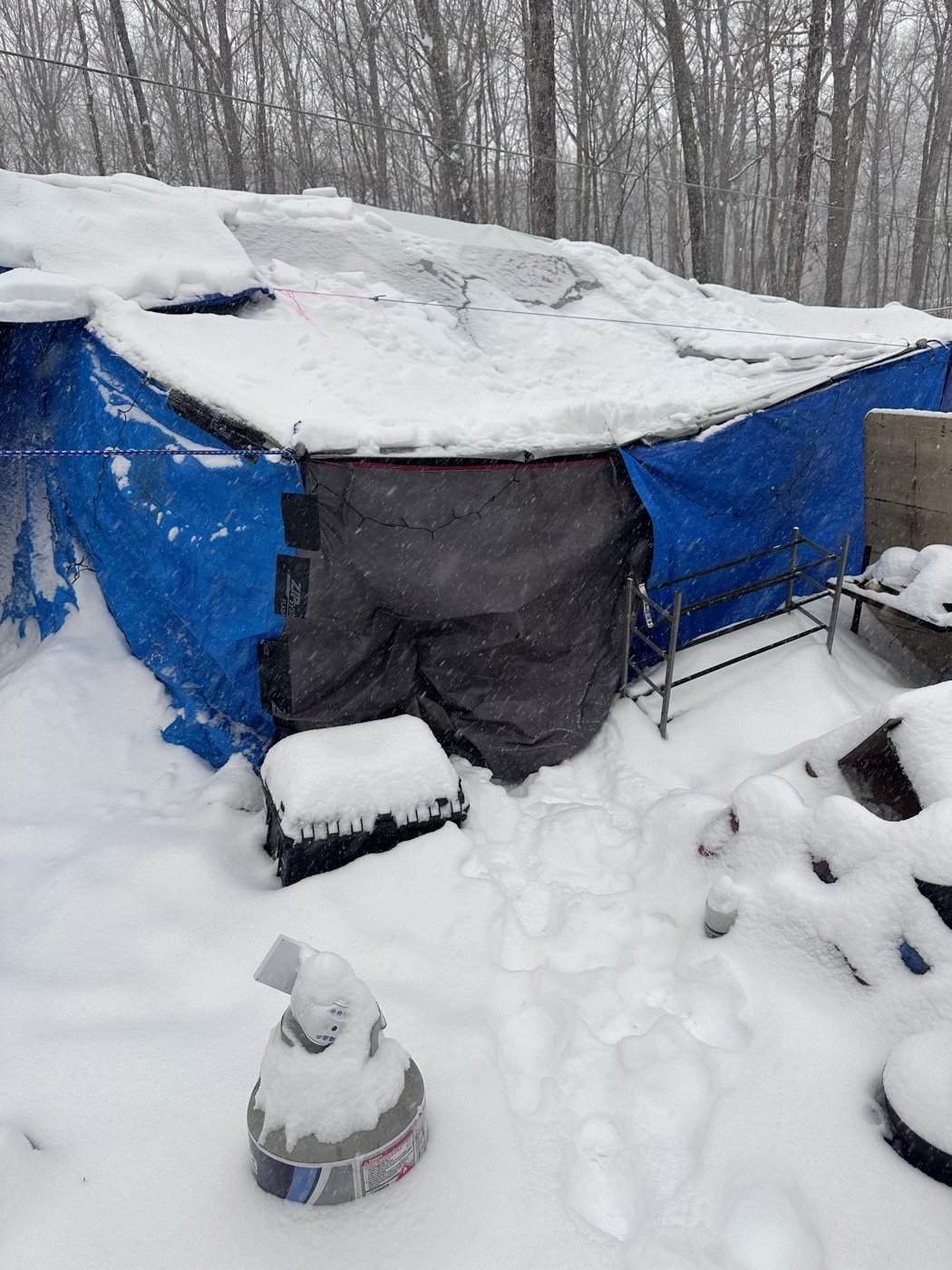 An unsheltered winter encampment covered in snow